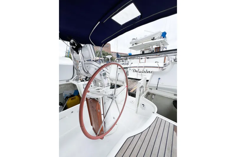 Slide: The Image of 2007 Beneteau 373 sailboat cockpit with steering wheel and navigation equipment. - 51