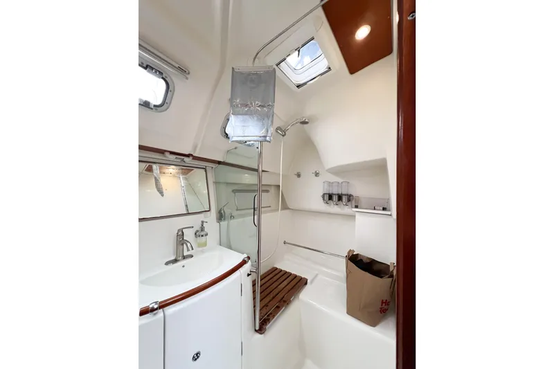 Slide: The Image of 2007 Beneteau 373 yacht bathroom with shower, sink, and wooden accents. - 53