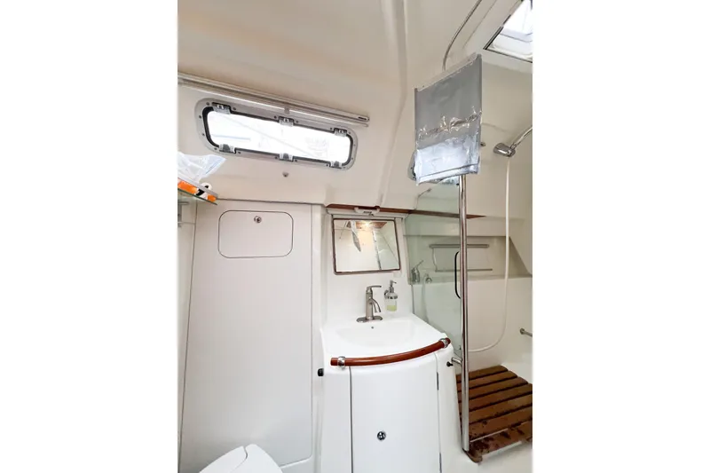 Slide: The Image of 2007 Beneteau 373 yacht bathroom with sink, mirror, and shower area. - 55