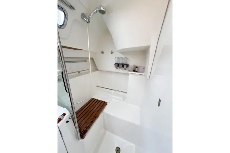 Slide: The Image of Interior shower of 2007 Beneteau 373 sailboat with wooden seat and dispensers. - 57