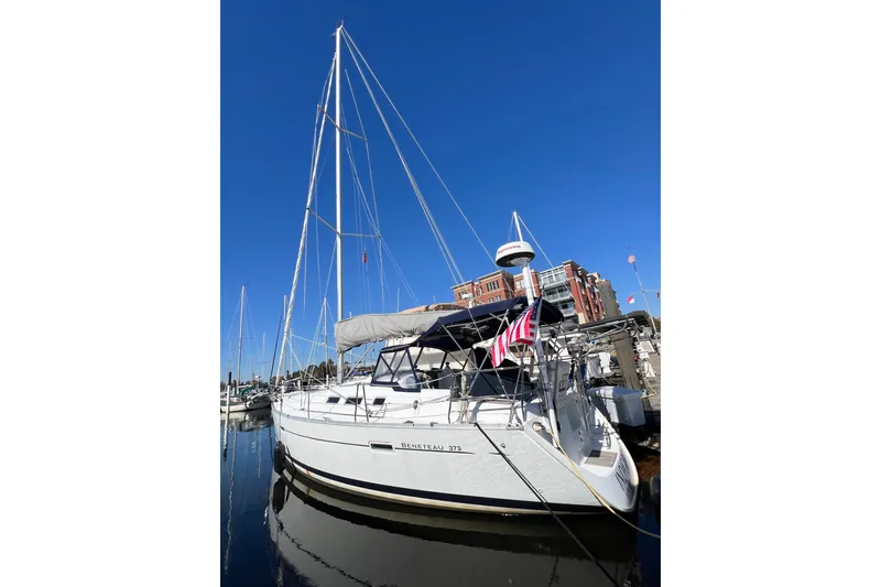 Slide: The Image of 2007 Beneteau 373 sailboat docked in marina under clear blue sky. - 6
