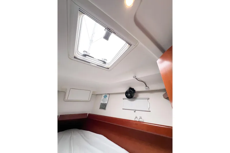 Slide: The Image of Interior cabin of 2007 Beneteau 373 sailboat with skylight and wooden accents. - 63