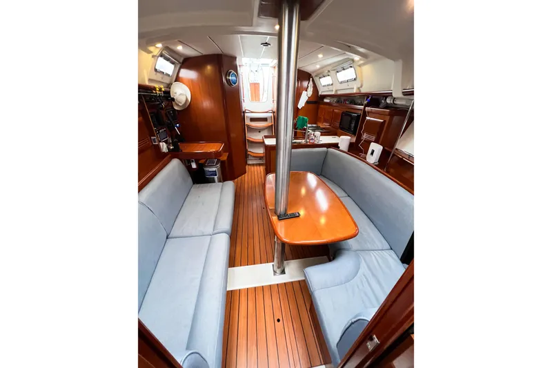 Slide: The Image of Interior of 2007 Beneteau 373 sailboat with wood finish and cozy seating area. - 64