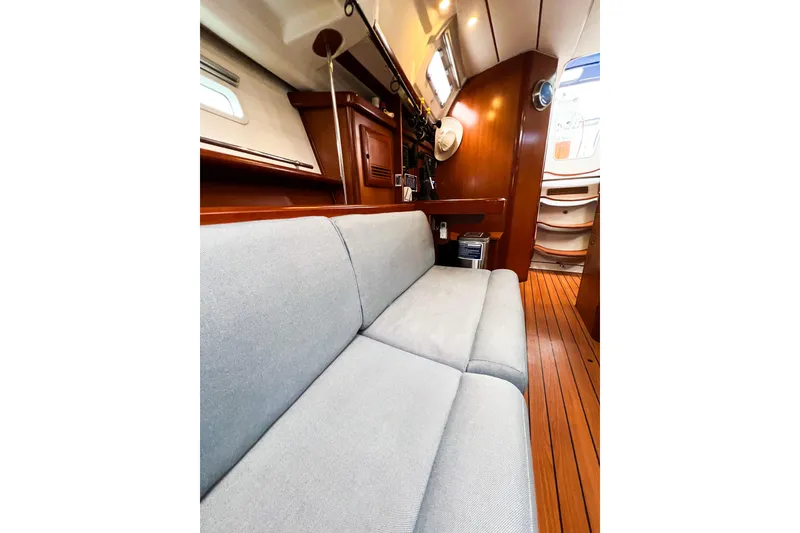Slide: The Image of Interior of 2007 Beneteau 373 sailboat with wooden flooring and comfortable seating. - 66