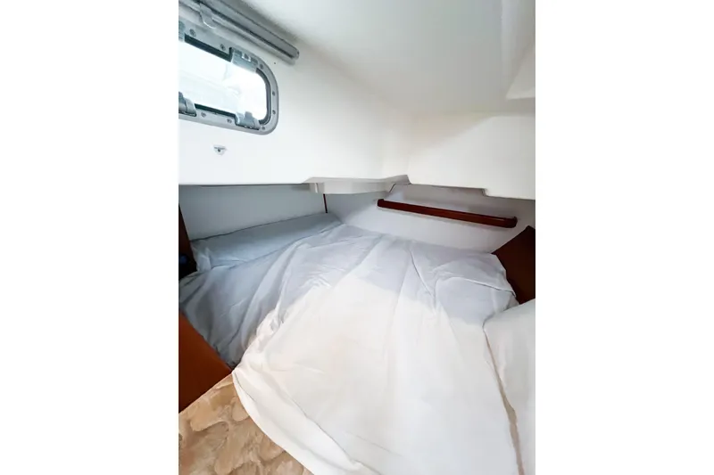 Slide: The Image of Cozy cabin interior of 2007 Beneteau 373 sailboat with bed and window. - 68