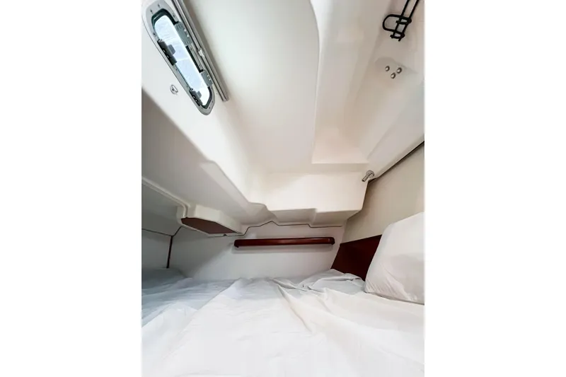 Slide: The Image of 2007 Beneteau 373 yacht interior cabin with bed and porthole window. - 69