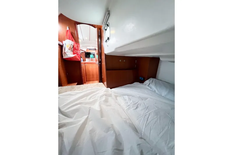 Slide: The Image of Interior cabin of 2007 Beneteau 373 sailboat, featuring cozy sleeping area and wooden finishes. - 71