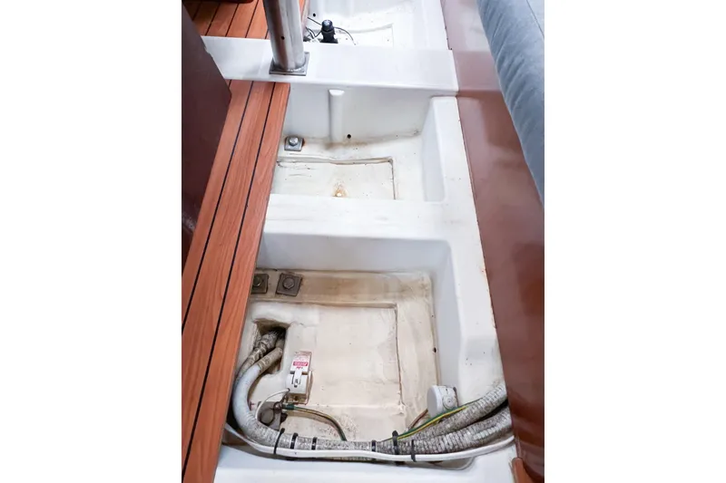 Slide: The Image of Interior view of 2007 Beneteau 373 sailboat, showcasing storage compartments and wiring. - 74