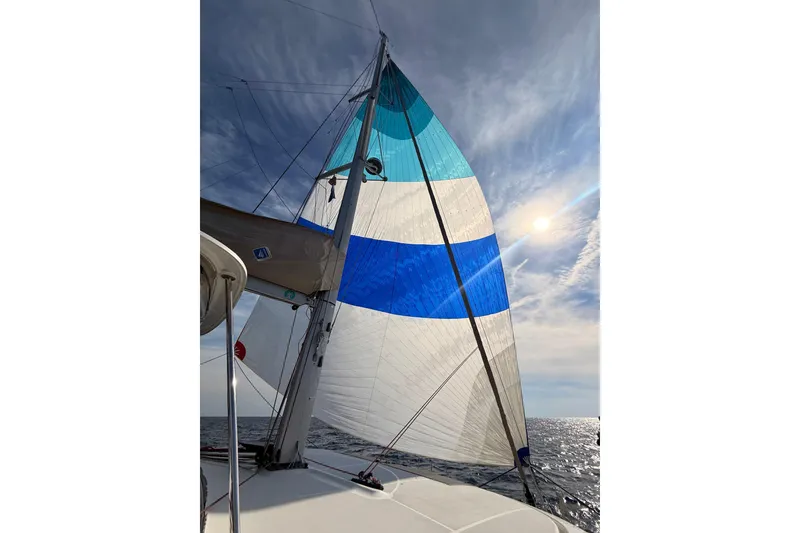 Slide: The Image of Sailing on a 2021 Lagoon 46 Owner's Version catamaran under a vibrant blue sky. - 103