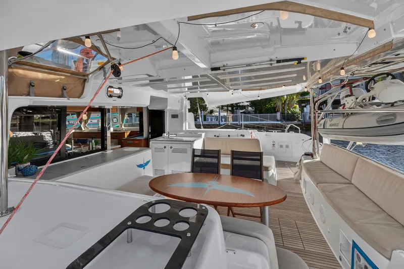 Slide: The Image of Luxurious 2021 Lagoon 46 Owner's Version yacht interior with elegant seating and dining area. - 20