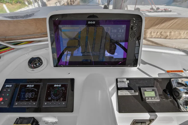 Slide: The Image of Helm of 2021 Lagoon 46 Owner's Version with navigation displays and controls. - 36