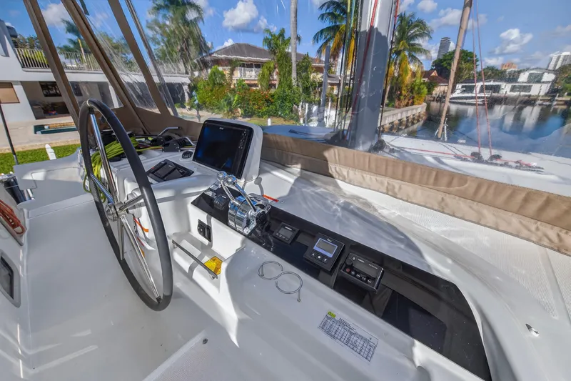 Slide: The Image of Cockpit of 2021 Lagoon 46 Owner's Version catamaran with steering wheel and navigation equipment. - 38