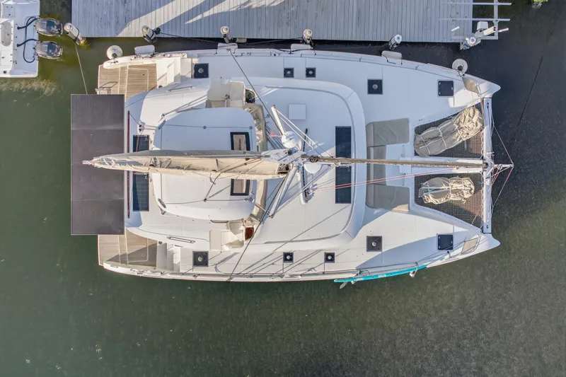 Slide: The Image of Aerial view of 2021 Lagoon 46 Owner's Version catamaran docked at a marina. - 5