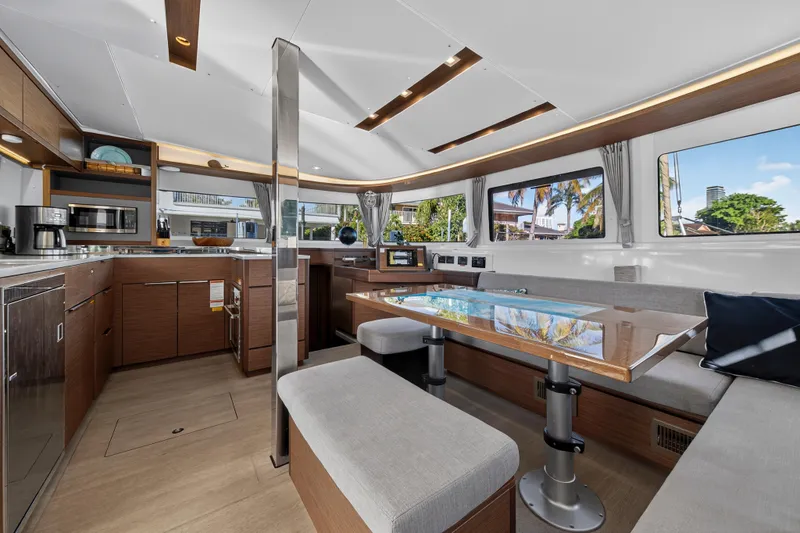 Slide: The Image of Luxurious interior of 2021 Lagoon 46 Owner's Version catamaran with modern kitchen and seating area. - 51