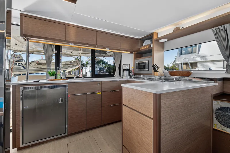 Slide: The Image of Modern kitchen interior of 2021 Lagoon 46 Owner's Version yacht, featuring sleek cabinetry and appliances. - 62