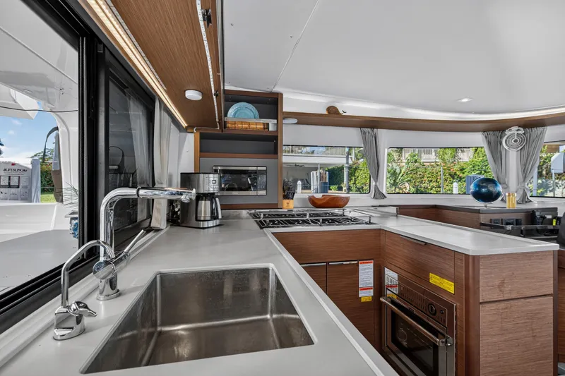 Slide: The Image of Modern kitchen interior of 2021 Lagoon 46 Owner's Version catamaran, featuring sleek design and appliances. - 65