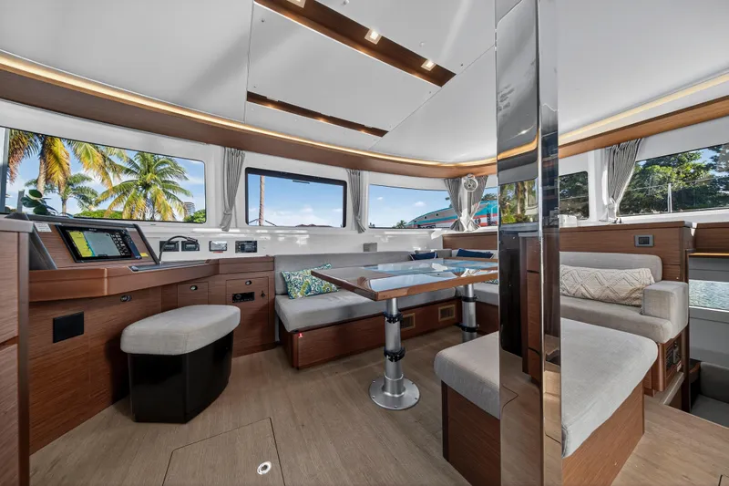 Slide: The Image of Luxurious interior of 2021 Lagoon 46 Owner's Version catamaran with modern seating and navigation area. - 69