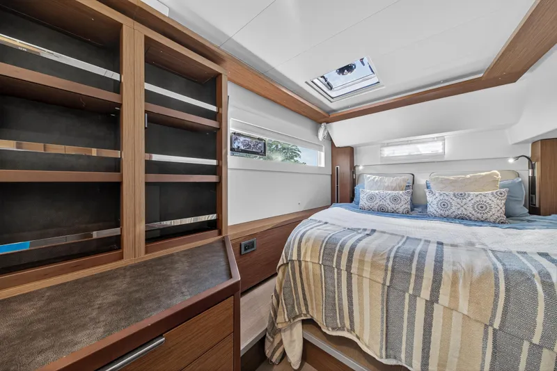 Slide: The Image of Luxurious bedroom interior of 2021 Lagoon 46 Owner's Version yacht with skylight and cozy bedding. - 75