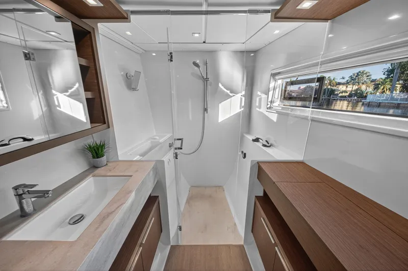 Slide: The Image of Luxurious bathroom in 2021 Lagoon 46 Owner's Version yacht, featuring modern fixtures and natural light. - 79
