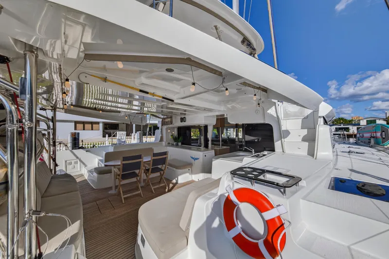 Slide: The Image of Luxurious 2021 Lagoon 46 Owner's Version catamaran with spacious deck and seating area. - 8