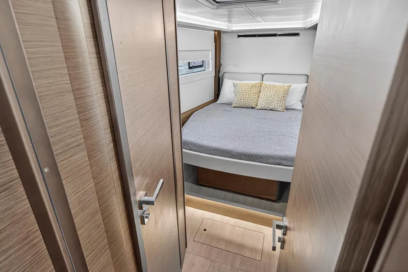 Slide: The Image of Luxurious bedroom in 2021 Lagoon 46 Owner's Version catamaran, featuring modern design and cozy bedding. - 84
