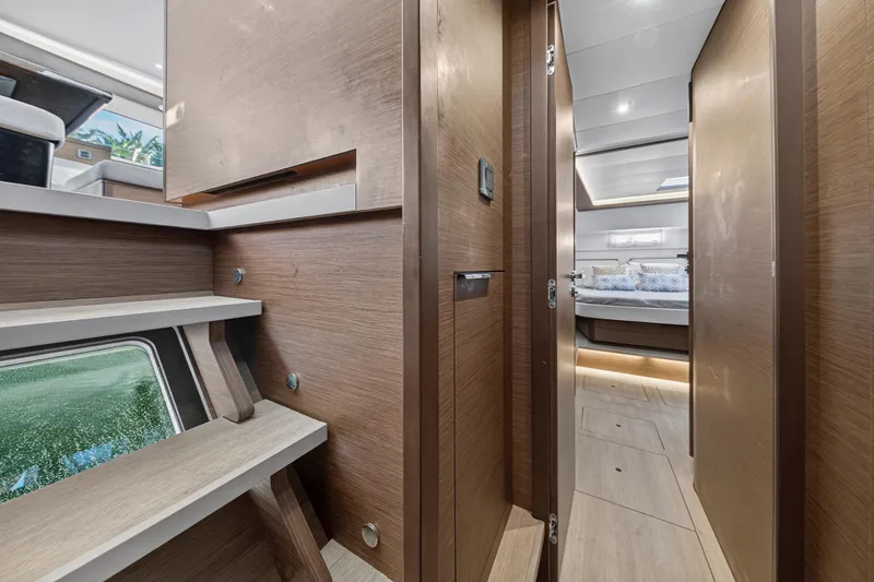 Slide: The Image of Interior of 2021 Lagoon 46 Owner's Version yacht, featuring modern wood finishes and cozy bedroom. - 92