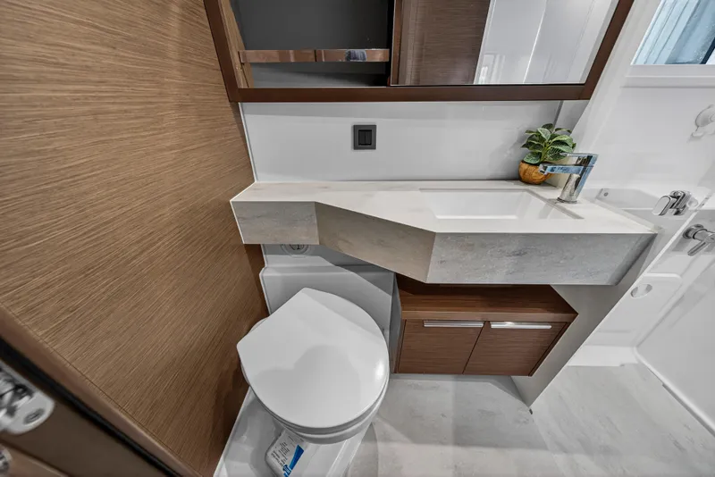 Slide: The Image of Modern bathroom in 2021 Lagoon 46 Owner's Version yacht, featuring sleek design and compact fixtures. - 98