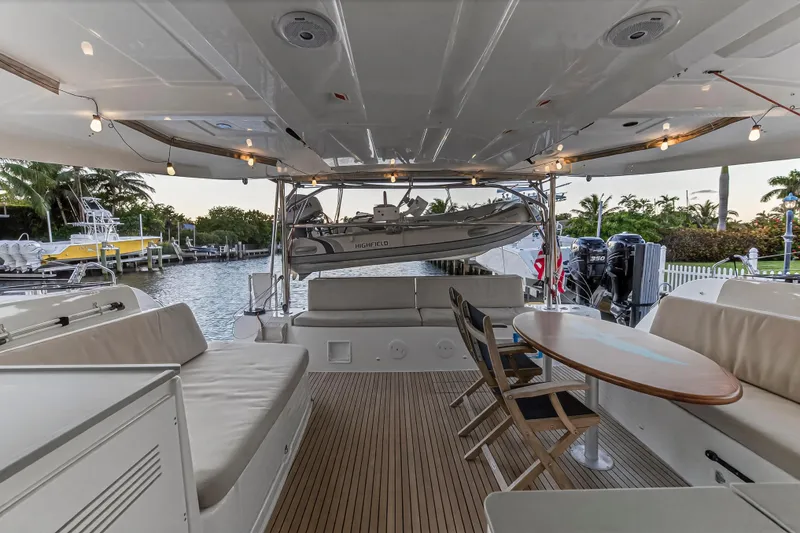 Slide: The Image of Spacious deck of 2021 Lagoon 46 Owner's Version yacht with seating and table. - 99