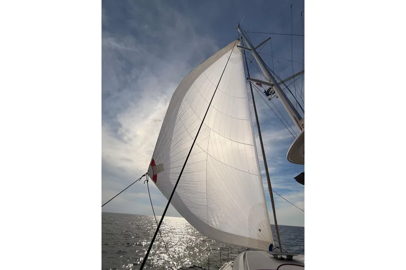Slide: The Image of Sailing on a 2021 Lagoon 46 Owner's Version catamaran under a clear sky. - 104