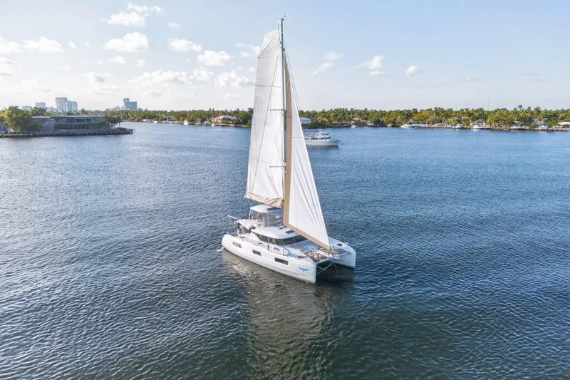 Slide: The Image of Sailing Lagoon 46 Owner's Version catamaran, 2021 model, on calm waters under clear skies. - 112