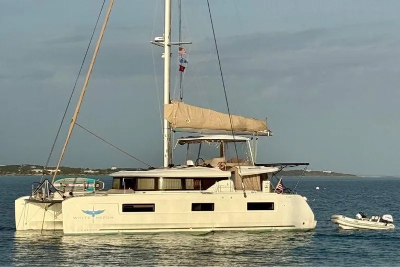 Slide: The Image of 2021 Lagoon 46 Owner's Version catamaran anchored in calm waters. - 124