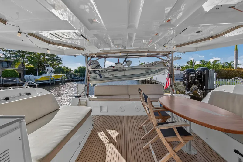 Slide: The Image of Spacious deck of 2021 Lagoon 46 Owner's Version catamaran with seating and dining area. - 13