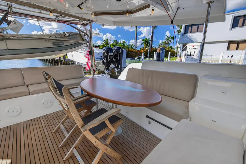 Slide: The Image of Spacious deck of 2021 Lagoon 46 Owner's Version yacht with seating and table. - 14