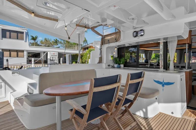Slide: The Image of Spacious deck of 2021 Lagoon 46 Owner's Version catamaran with seating and dining area. - 16