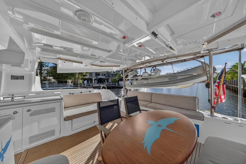 Slide: The Image of Luxurious 2021 Lagoon 46 Owner's Version yacht interior with elegant seating and scenic waterfront view. - 18