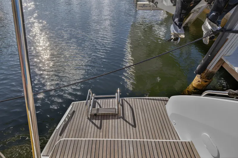 Slide: The Image of Lagoon 46 Owner's Version 2021 yacht stern with swim platform and ladder. - 22