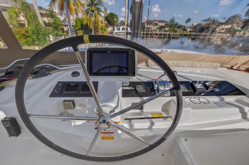 Slide: The Image of Steering wheel and controls of 2021 Lagoon 46 Owner's Version catamaran. - 35