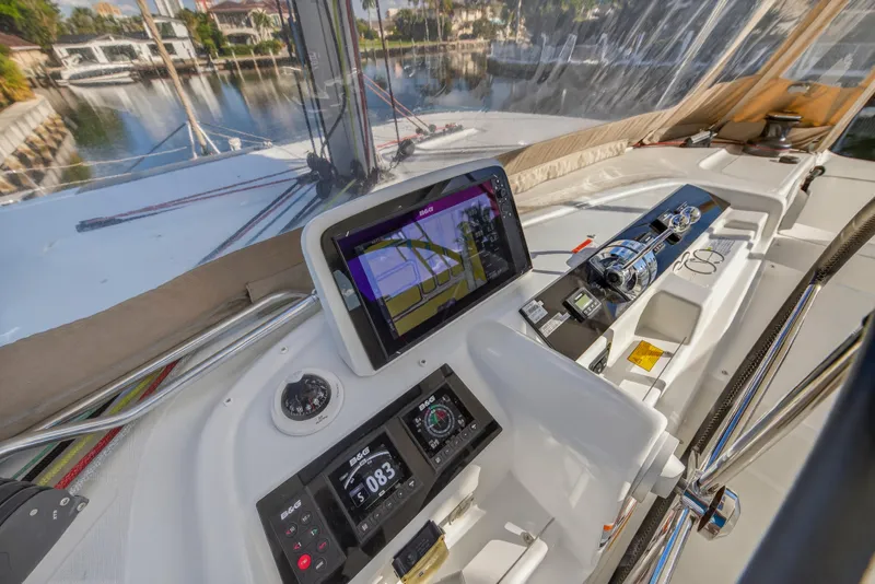 Slide: The Image of Helm station of 2021 Lagoon 46 Owner's Version catamaran with navigation equipment and controls. - 37