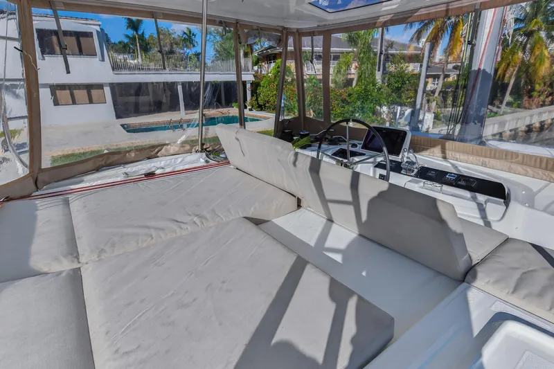 Slide: The Image of Luxurious Lagoon 46 Owner's Version 2021 yacht interior with spacious seating and helm. - 48