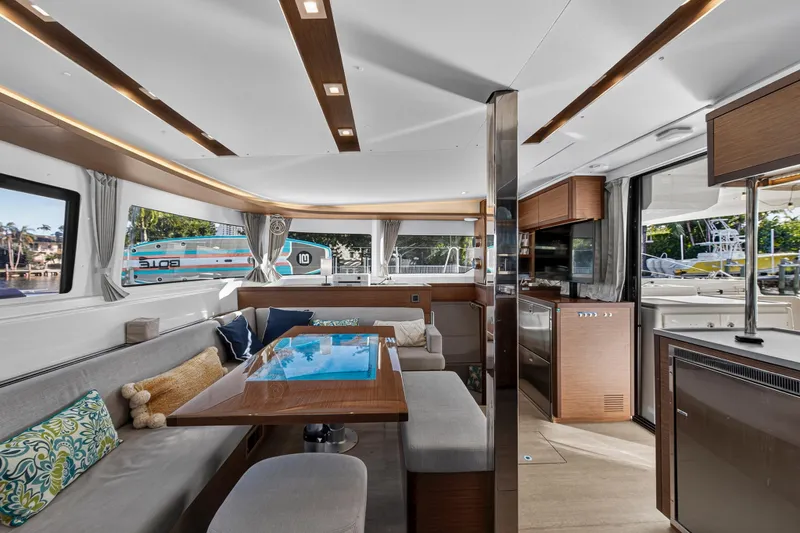 Slide: The Image of Luxurious interior of 2021 Lagoon 46 Owner's Version catamaran with modern furnishings and ample natural light. - 56