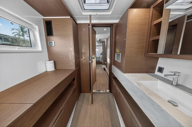 Slide: The Image of Luxurious interior of 2021 Lagoon 46 Owner's Version yacht, featuring modern wood finishes. - 80