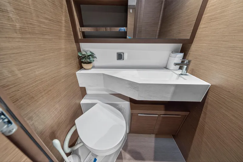 Slide: The Image of Modern bathroom in 2021 Lagoon 46 Owner's Version yacht with sleek design and compact fixtures. - 81