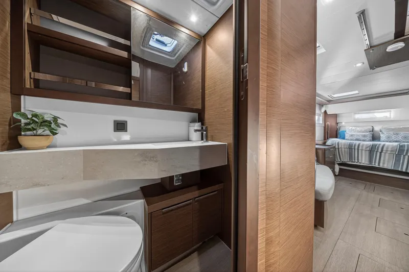 Slide: The Image of Luxurious interior of 2021 Lagoon 46 Owner's Version yacht, featuring modern bathroom and cozy bedroom. - 82