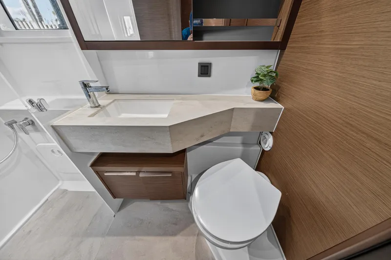 Slide: The Image of Modern bathroom in 2021 Lagoon 46 Owner's Version yacht, featuring sleek sink and toilet. - 91