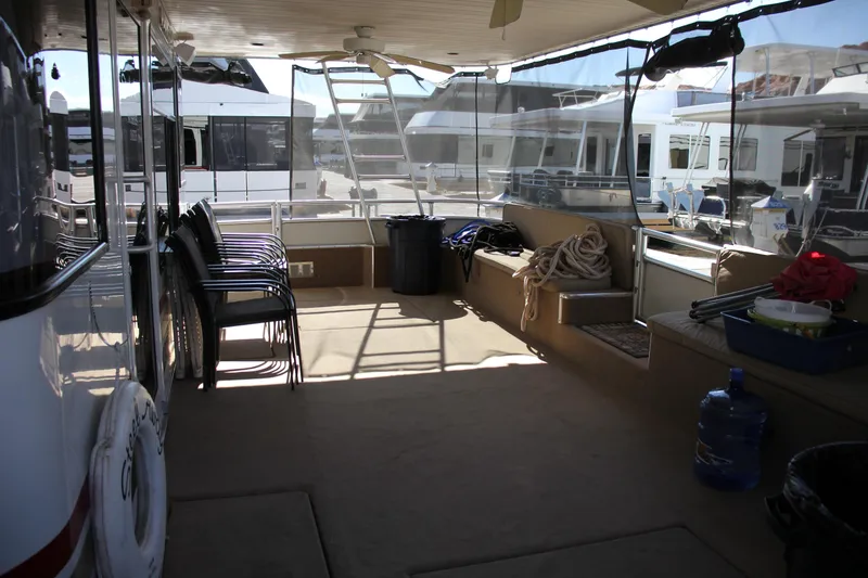 Slide: The Image of 2007 Sumerset Steel Away houseboat interior with chairs, ropes, and marina view. - 12