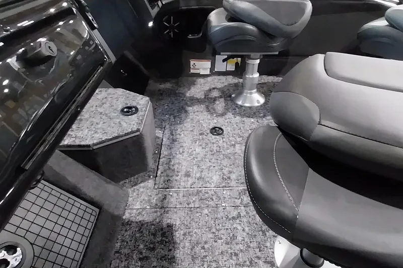 Slide: The Image of 2025 Tracker Targa V-19 WT boat interior with plush seating and carpeted flooring. - 11