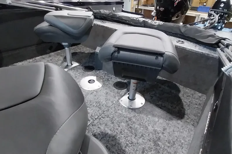Slide: The Image of 2025 Tracker Targa V-19 WT boat interior with swivel seats and carpeted flooring. - 12