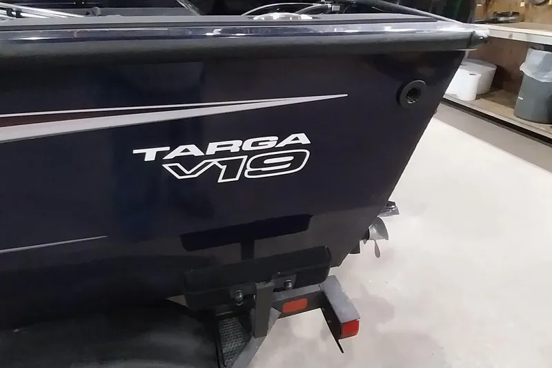 Slide: The Image of 2025 Tracker Targa V-19 WT boat rear view in a garage setting. - 14