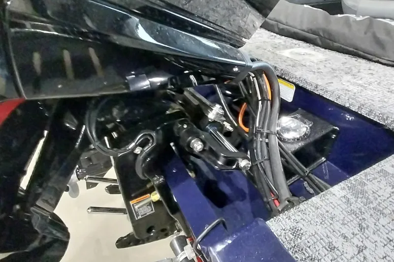 Slide: The Image of 2025 Tracker Targa V-19 WT boat engine compartment with cables and components. - 17