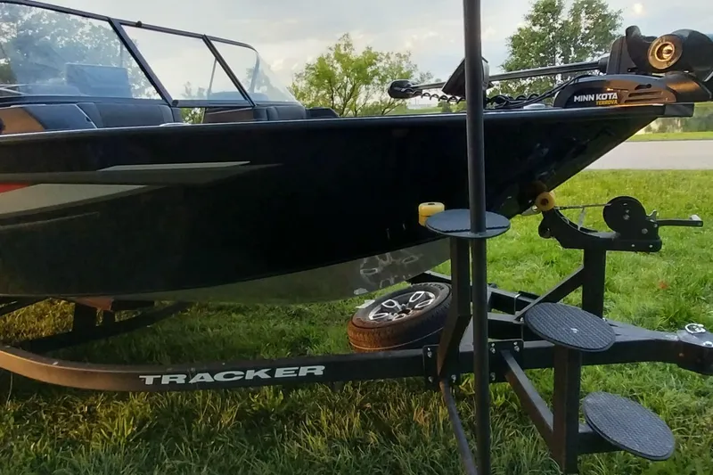 Slide: The Image of 2025 Tracker Targa V-19 WT boat on trailer, parked on grass. - 26